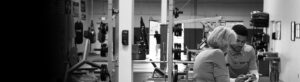 Ground Control employee talking with older woman in the gym area